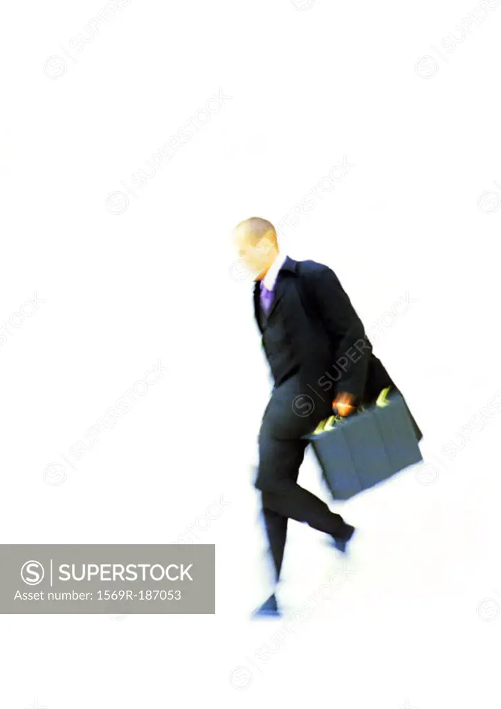 Businessman walking with briefcase in hand, elevated view