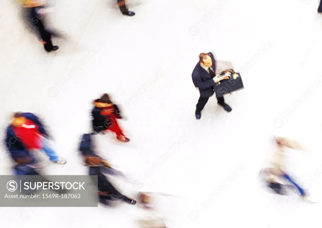 Businessman in crowd, elevated view, blurred