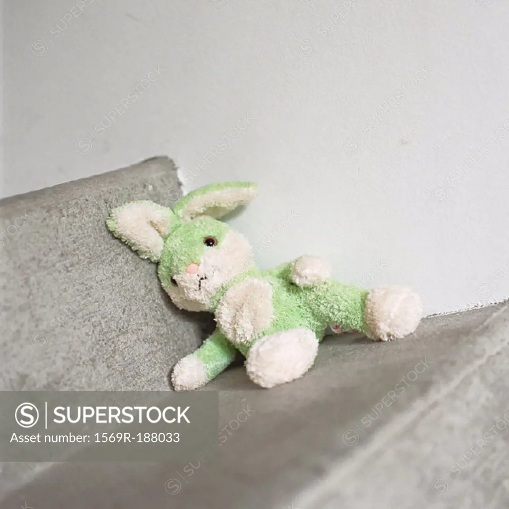 Stuffed rabbit sitting on step