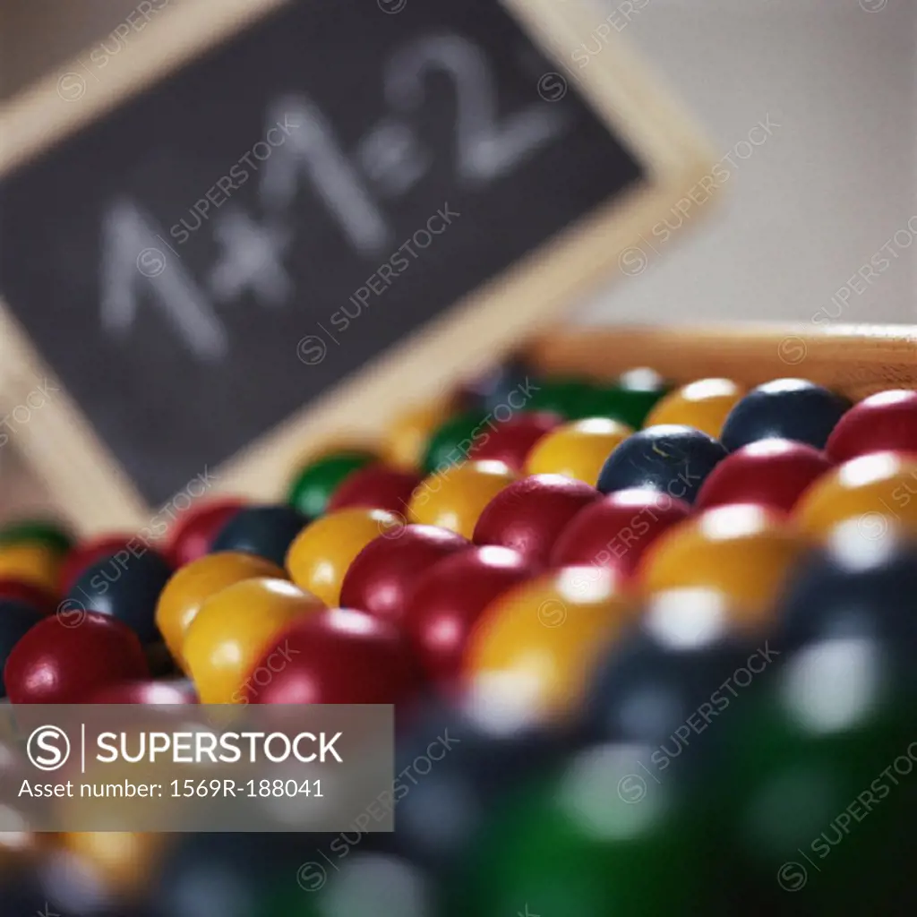 Abacus lying flat with chalk board in background