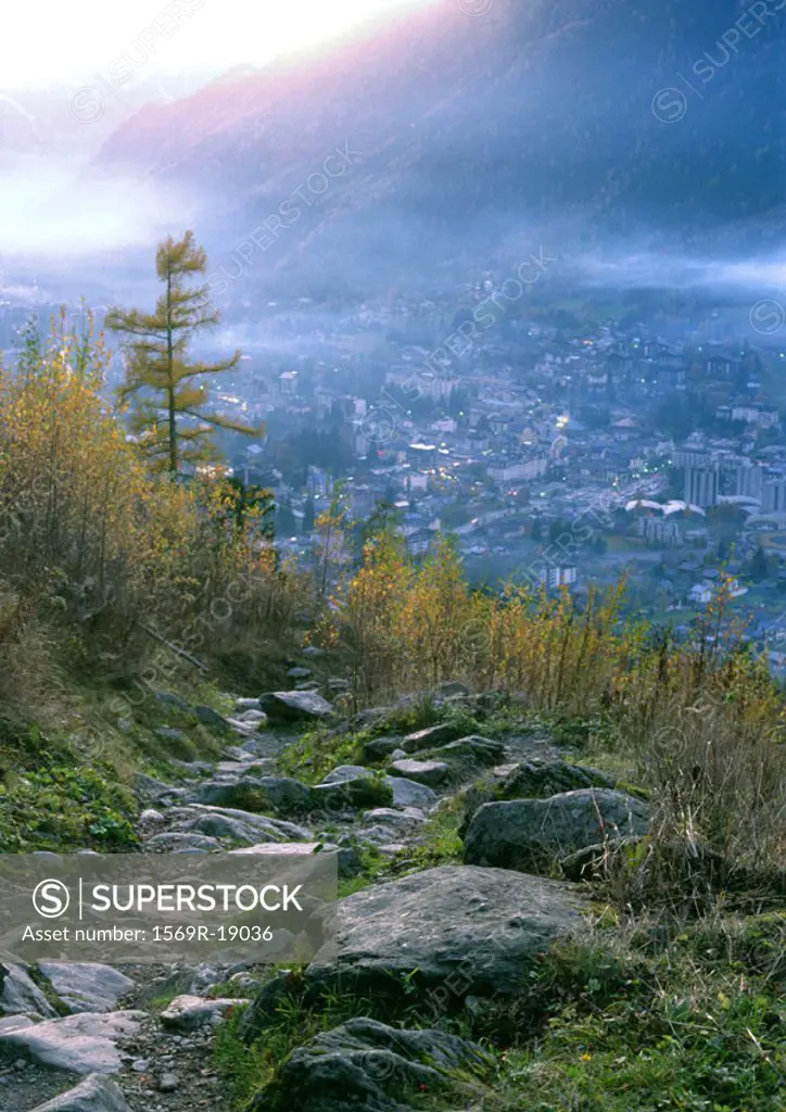 Rock path overlooking city in mountains