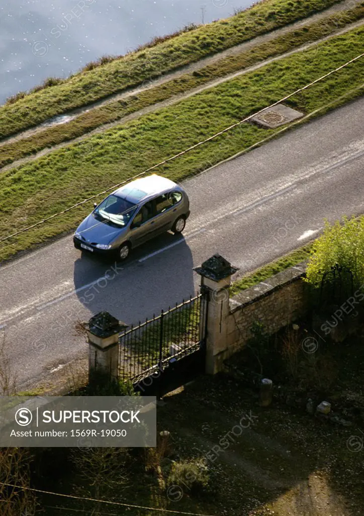 Car on road next to gate, high angle view