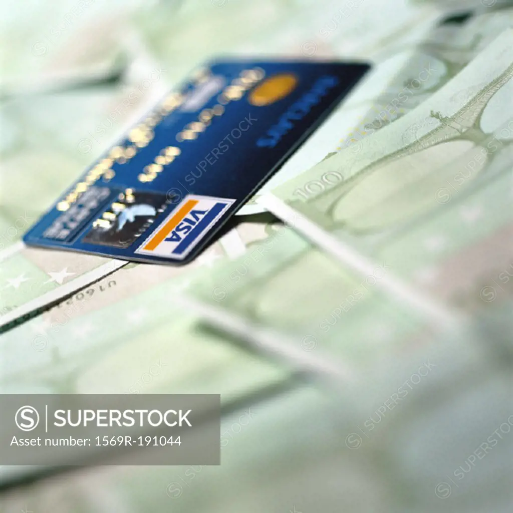 Visa card on top of euro bills