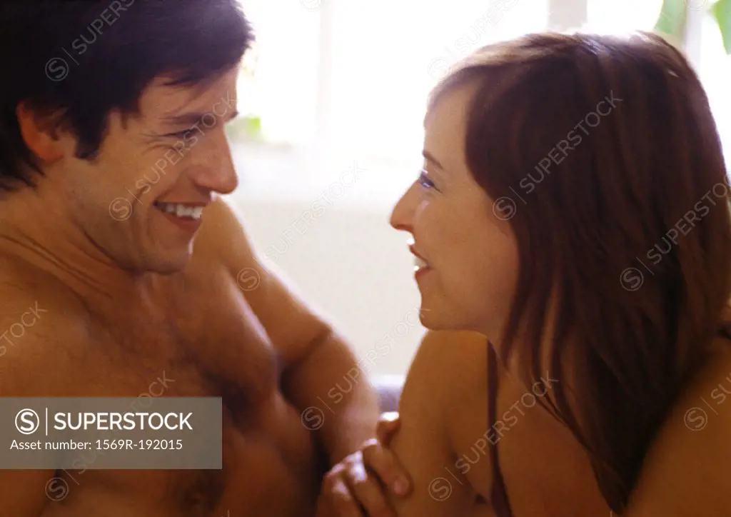 Man and woman smiling at each other, close-up