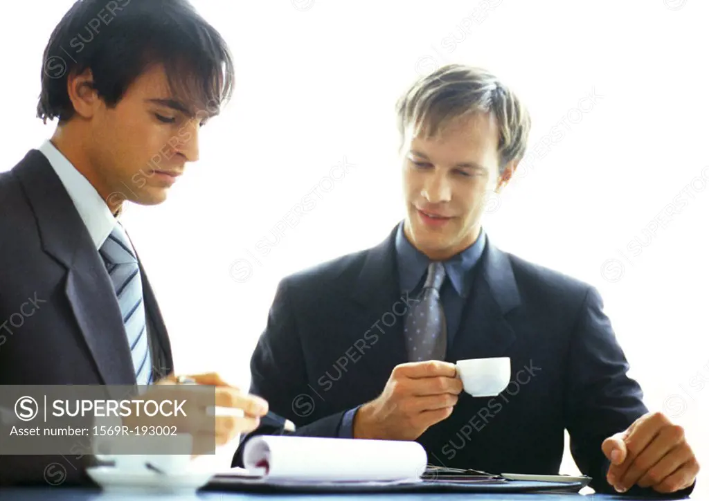 Businessmen working together with coffees