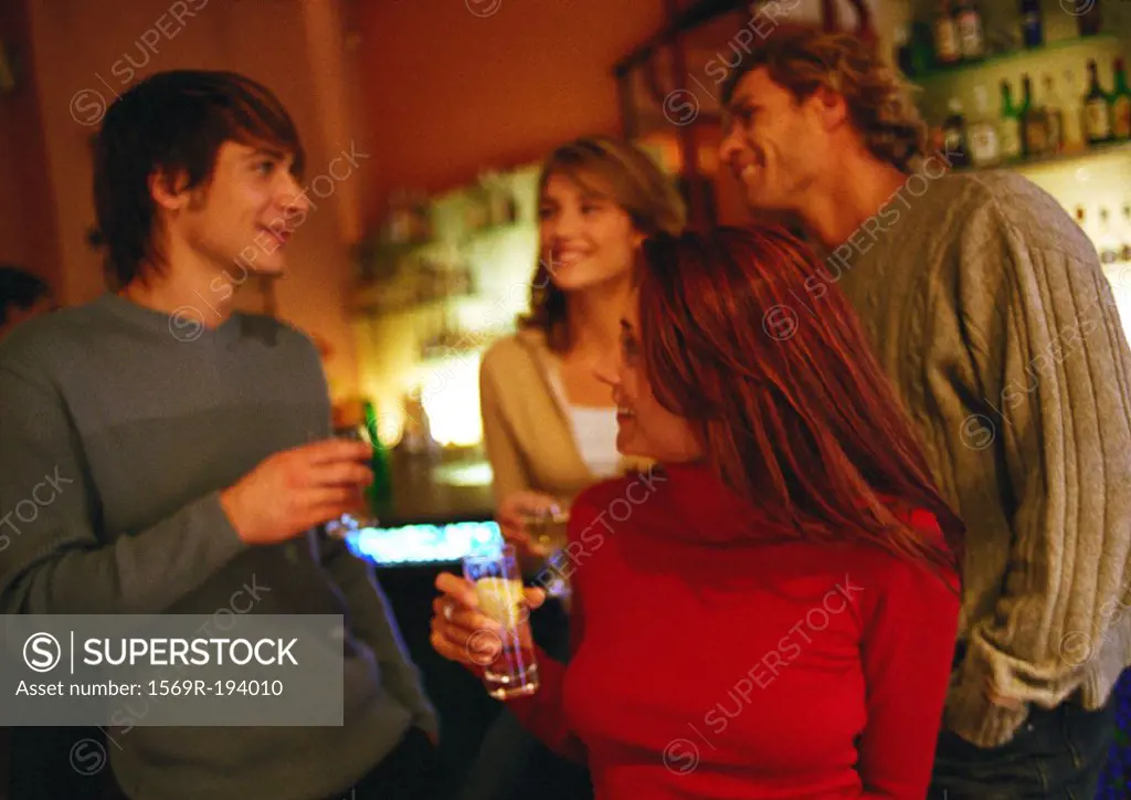 People talking and drinking together in a group