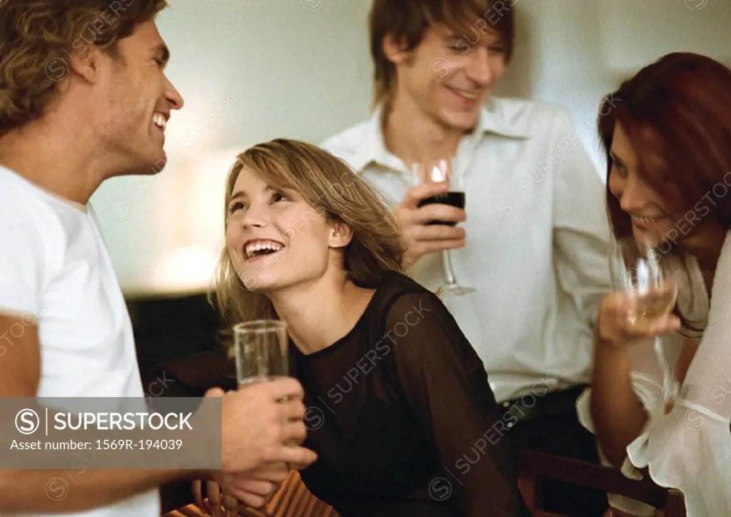 Young men and women drinking at bar