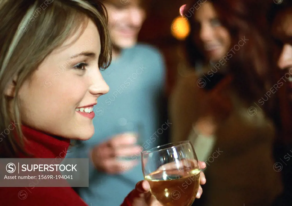 Woman drinking near group, close up
