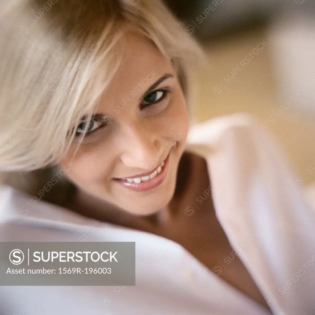 Woman smiling, looking at camera, portrait