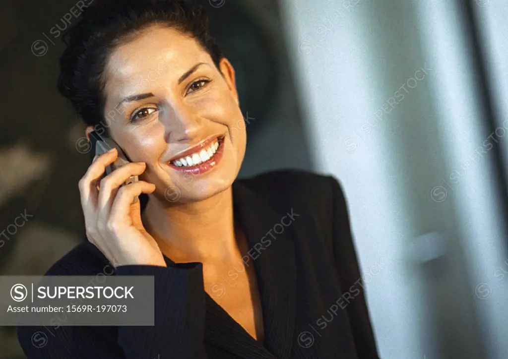 Businesswoman smiling, talking on cell phone, portrait