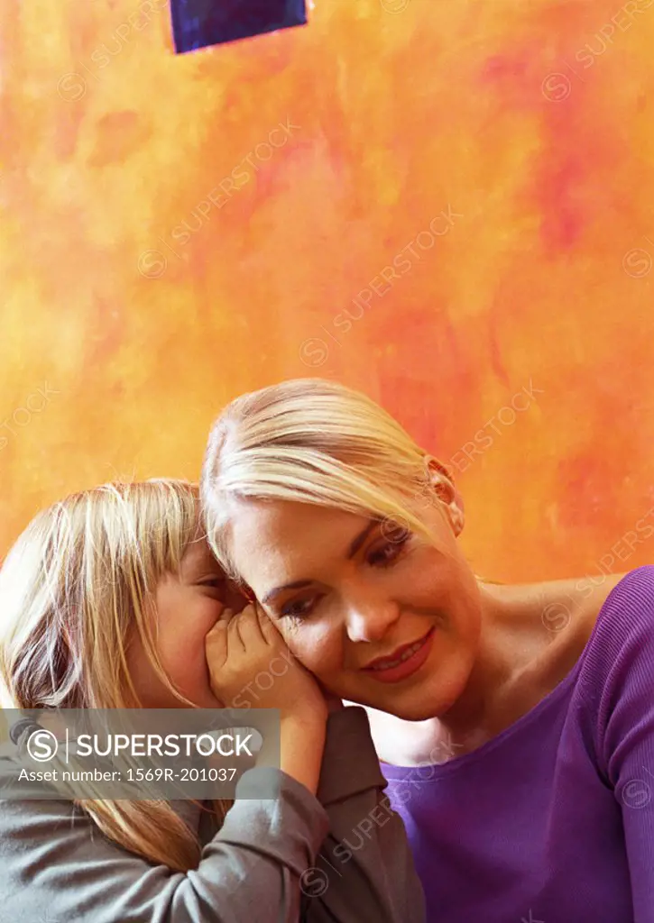 Daughter whispering to mother