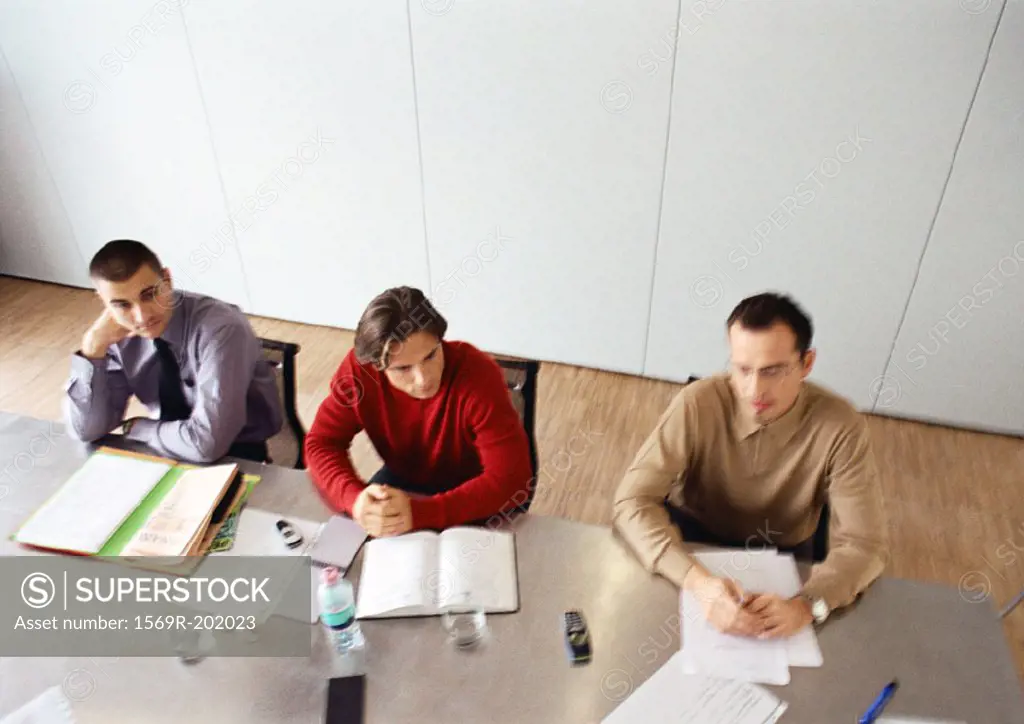 Businessmen sitting at table in office space