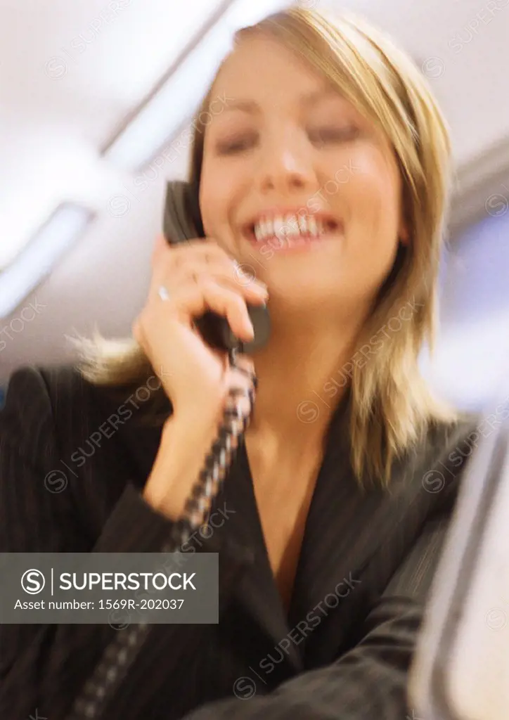 Businesswoman on phone smiling, blurred