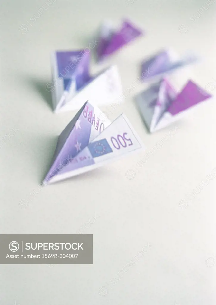 Five five-hundred-euro bills, folded into paper airplanes