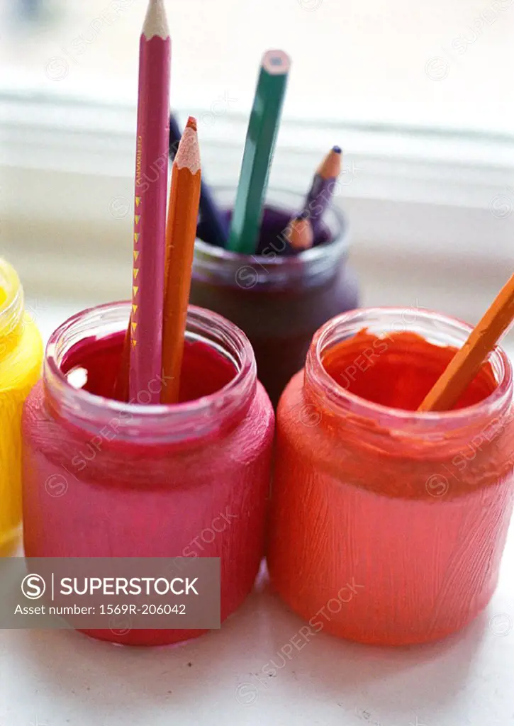 Paint jars holding colored pencils