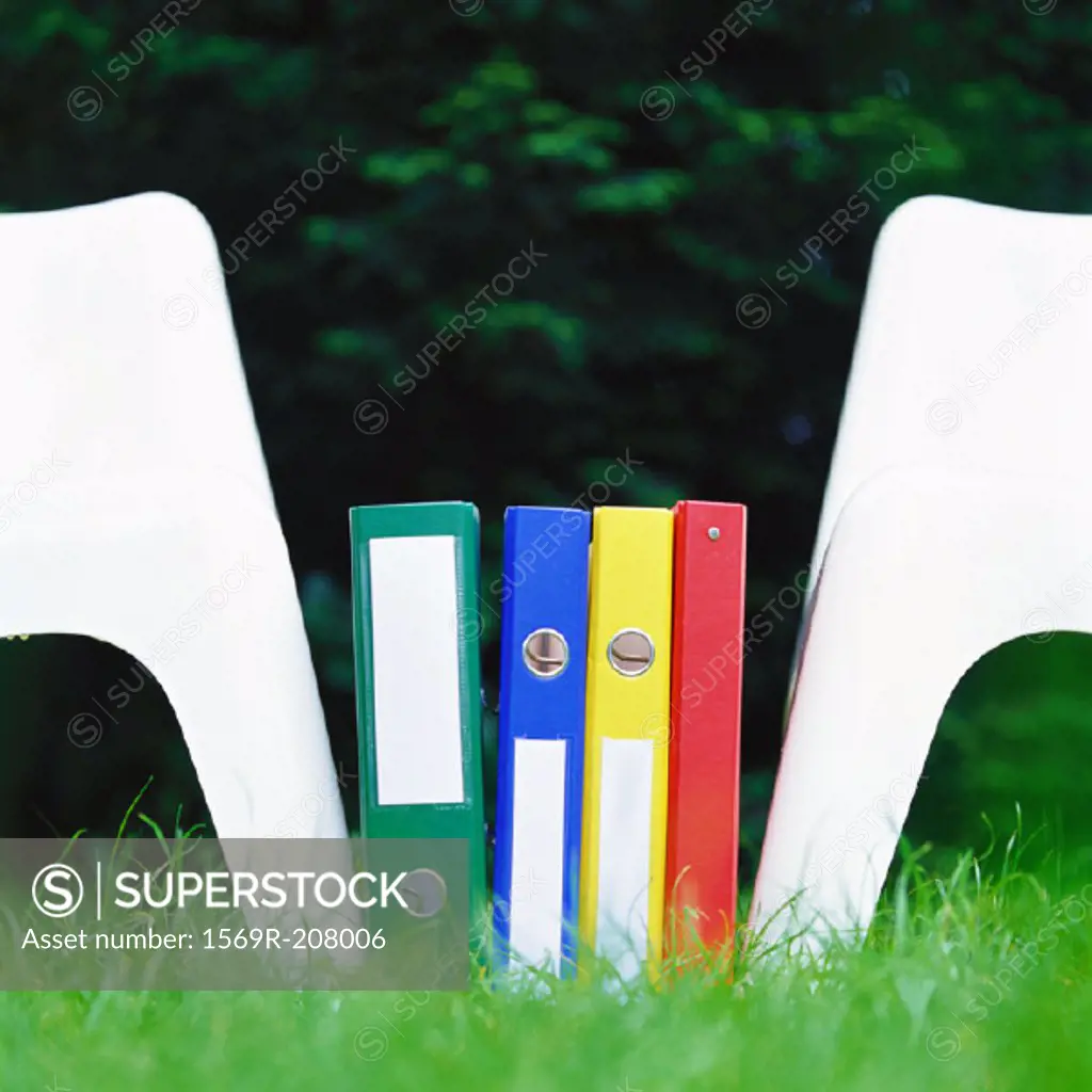 Files between two chairs on grass