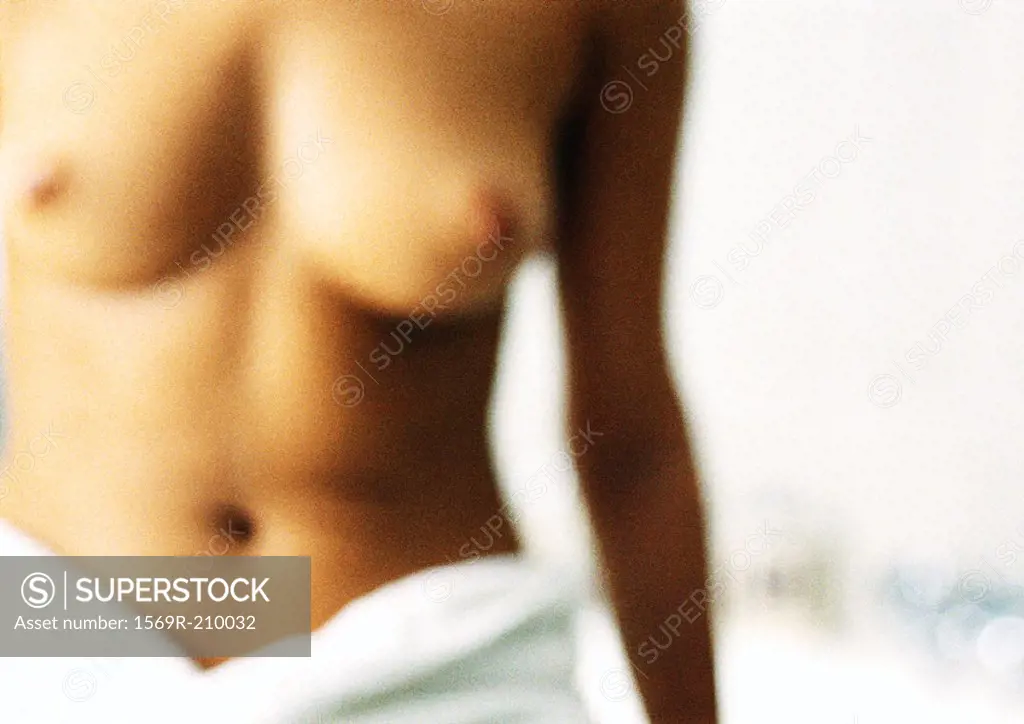 Semi-nude woman with bath towel around waist, blurred close-up