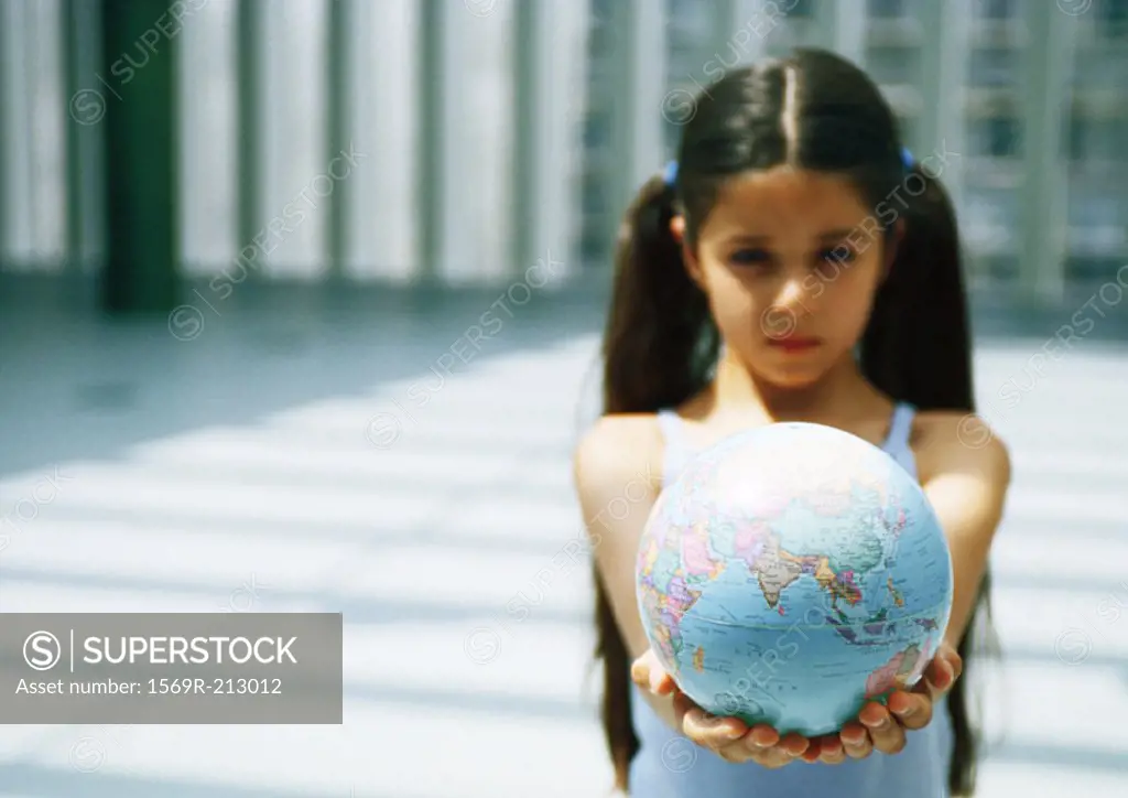 Girl holding out globe