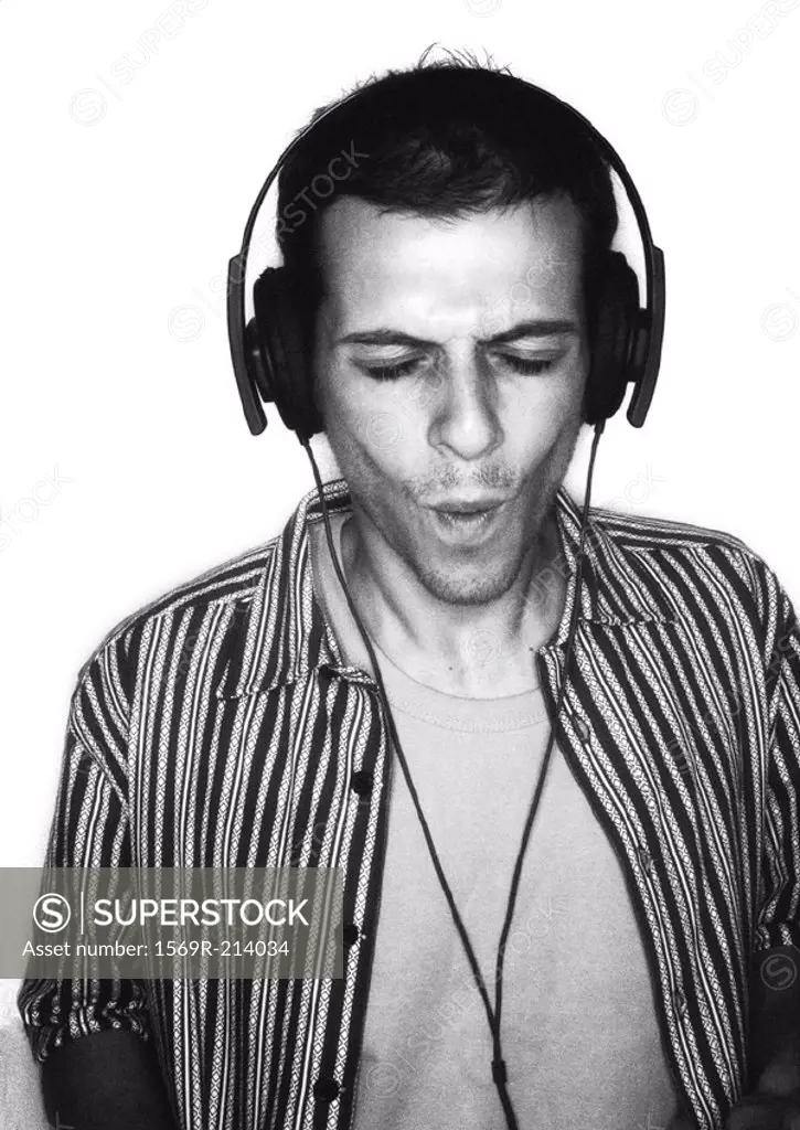 Man listening to headphones, portrait, b&w
