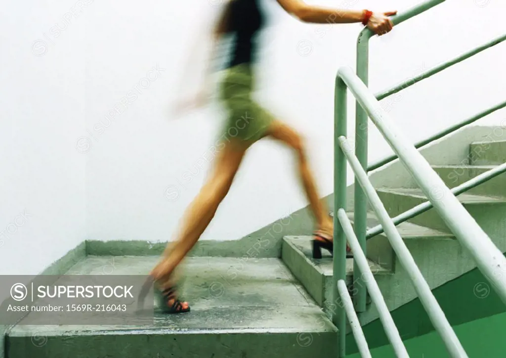 Woman walking up stairs, blurred