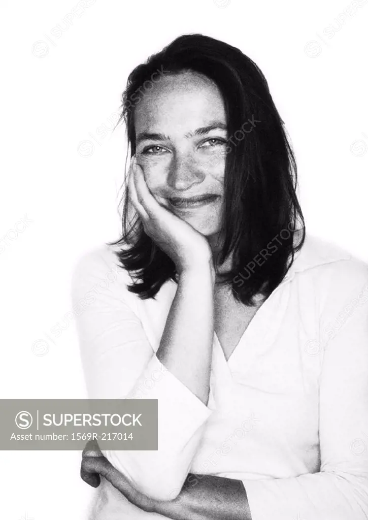 Woman smiling, hand on cheek, portait b&w
