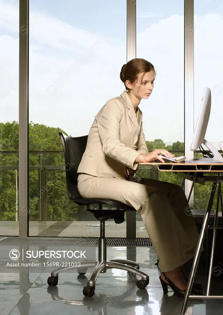 Businesswoman at desk, using computer