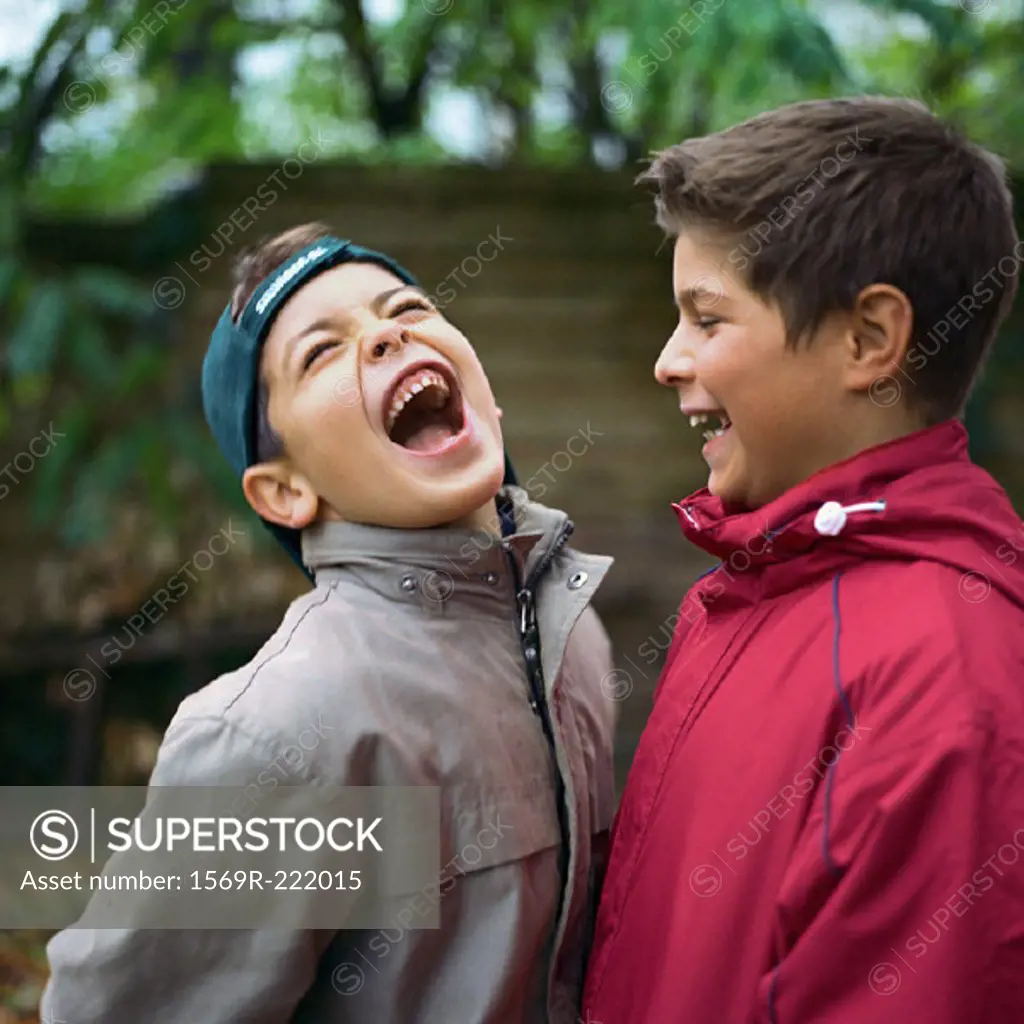 Two boys laughing outside