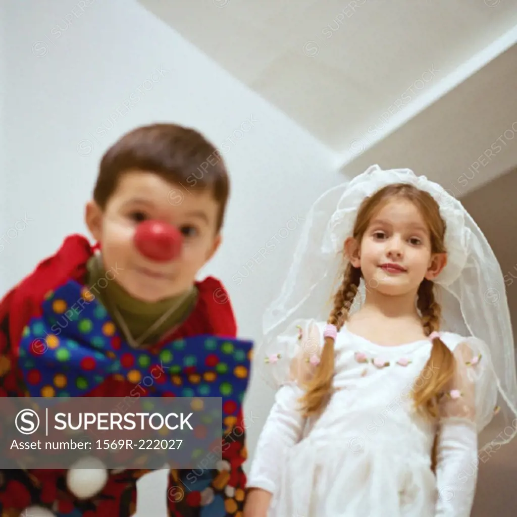 Girl and boy in costumes, low angle view
