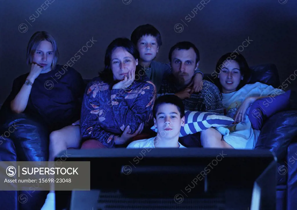 Family watching television together in the dark