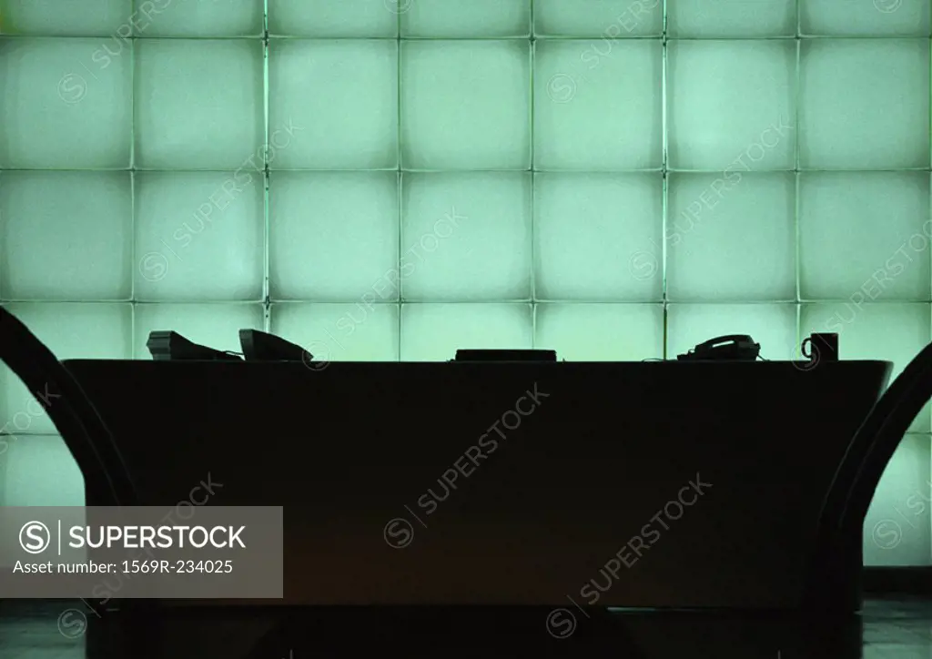 Desk in front of windows, silhouette