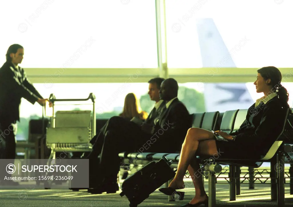 Business people in suits waiting in airport terminal
