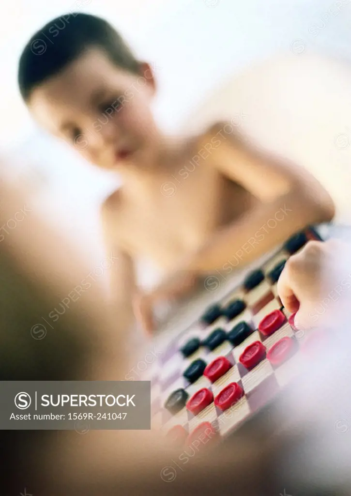 Children playing checkers, blurred