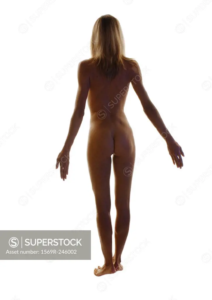 Nude woman standing with arms back, full length, rear view