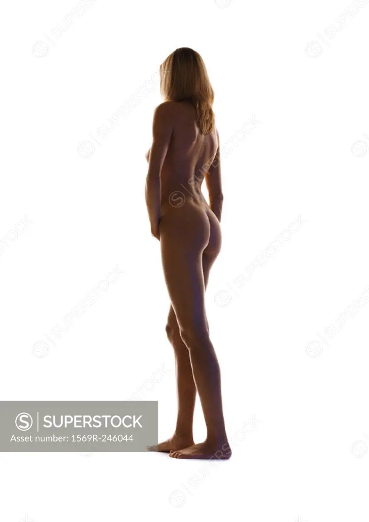 Nude woman standing, full length, rear view