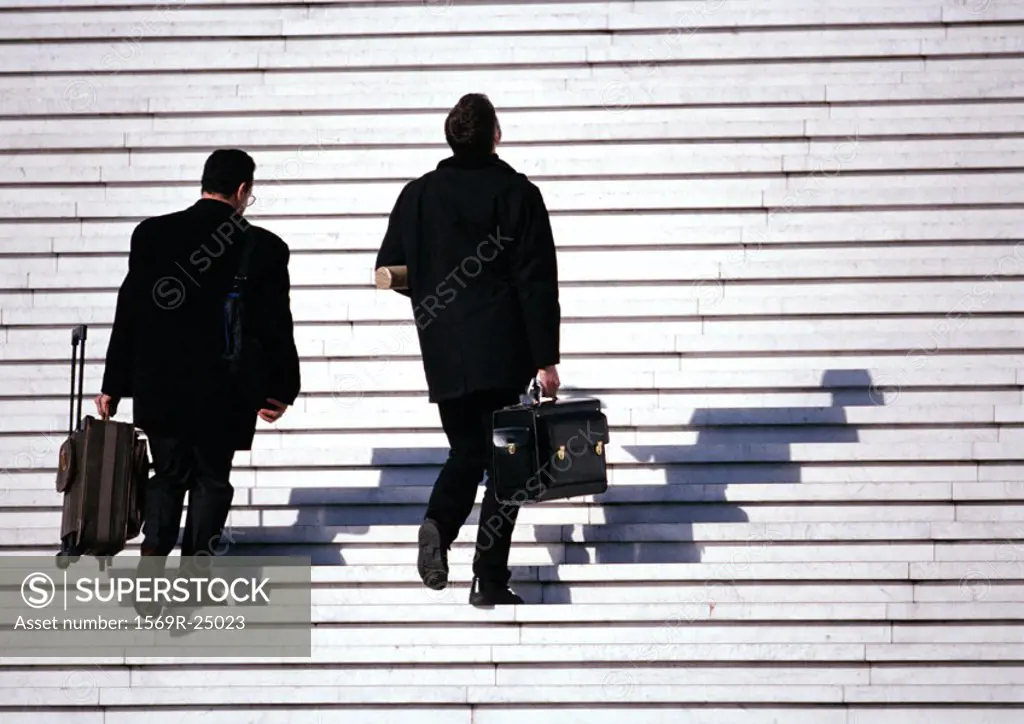 Businessmen walking up steps