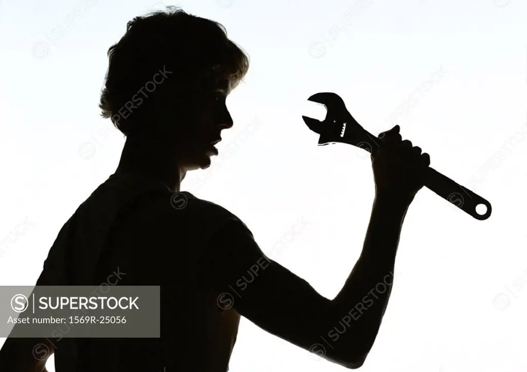 Woman holding wrench, silhouette