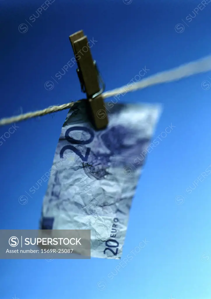 Twenty euro bill hanging on clothesline