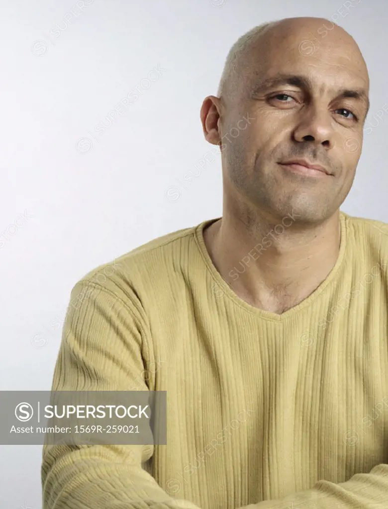 Man with head slightly turned, looking at camera