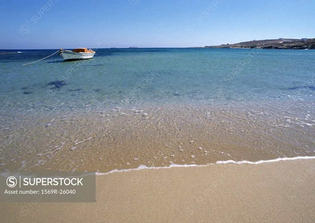 Greece, Cyclades, seashore with small anchored boat