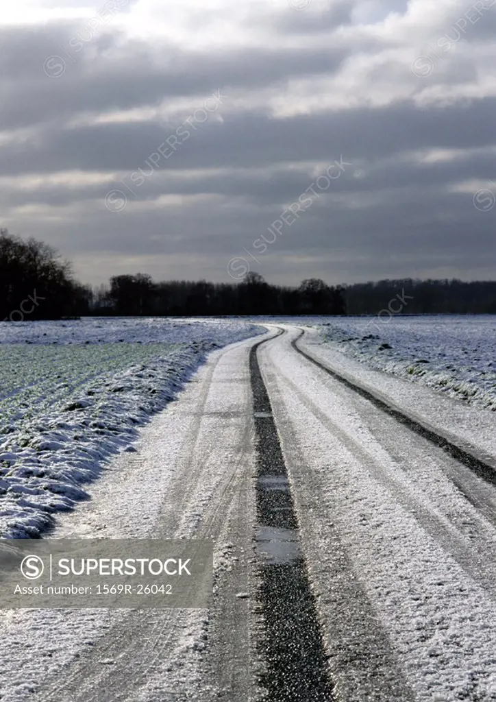 France, Picardy, road through fields with snow