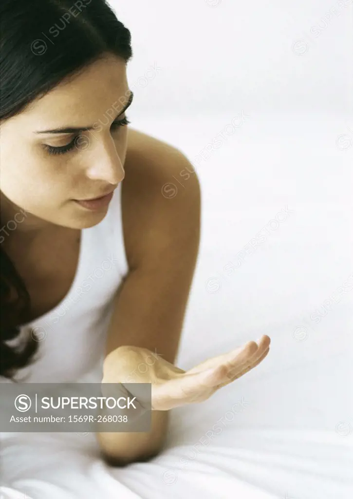 Woman looking at nails on bed
