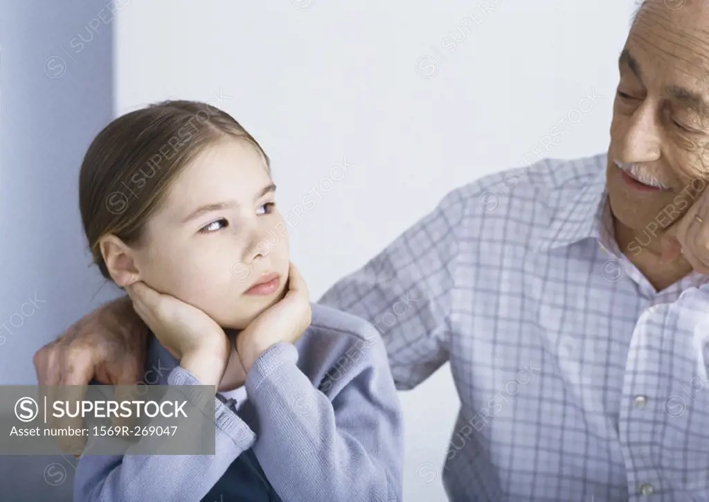 Grandfather with arm around girl