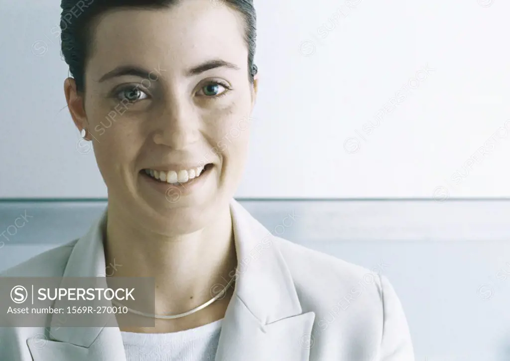 Businesswoman smiling at camera, close-up