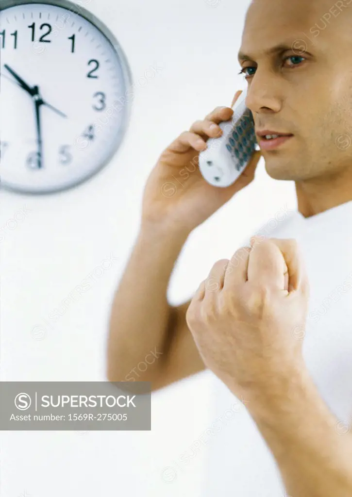 Man talking on phone, making fist