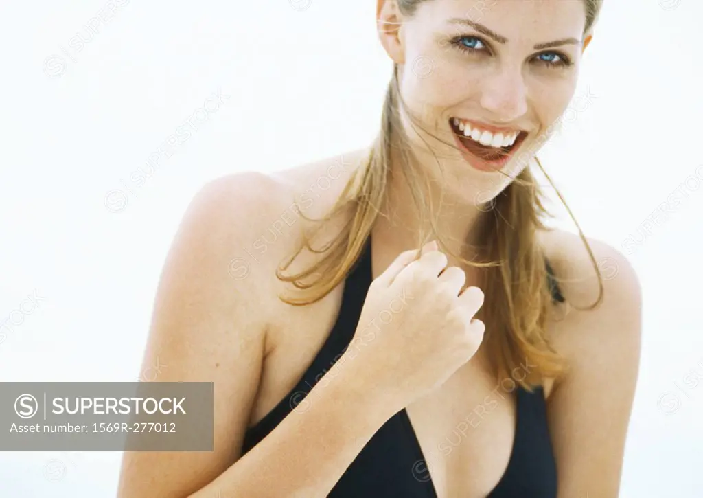 Young woman in bathing suit smiling, head and shoulders