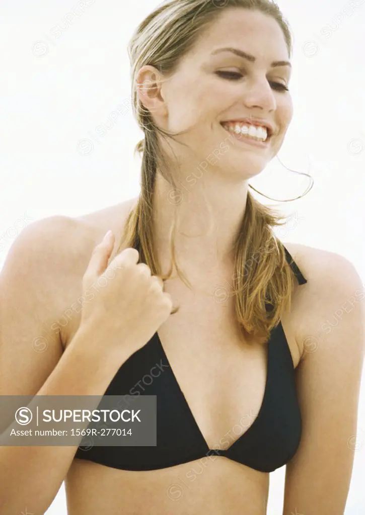 Young woman in bikini smiling, head and shoulders
