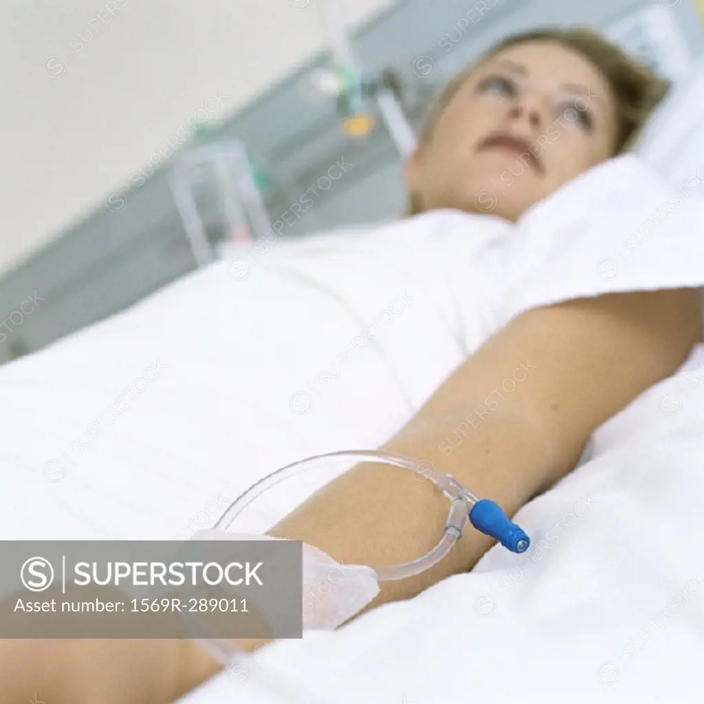 Female patient lying in hospital bed