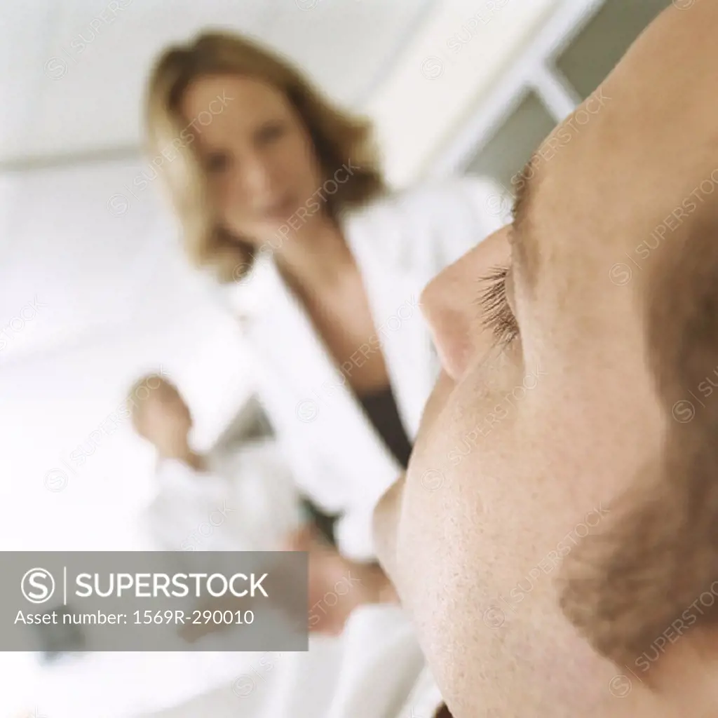 Doctor looking down at patient