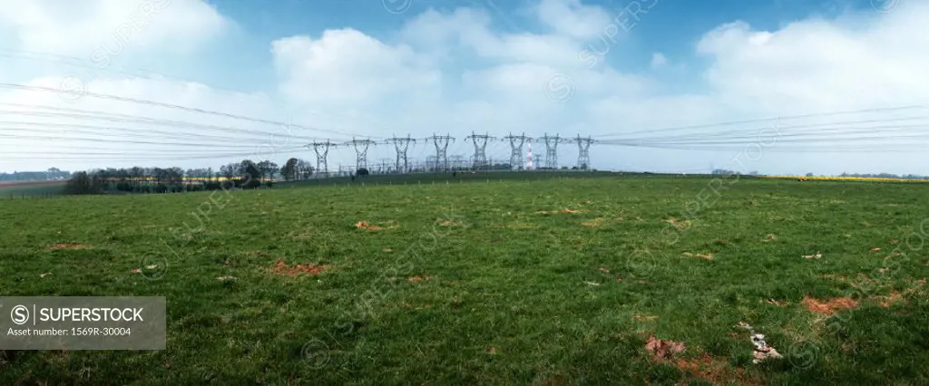 France, green field near a row of power lines
