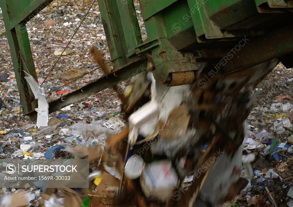 Dump truck dumping trash into landfill